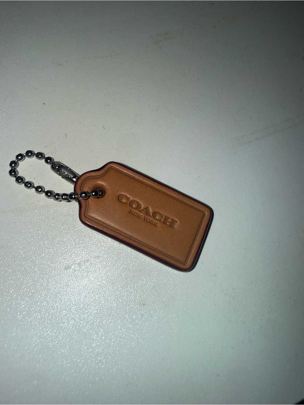 Coach Brown Leather hang  Tag from red denim nolita bag